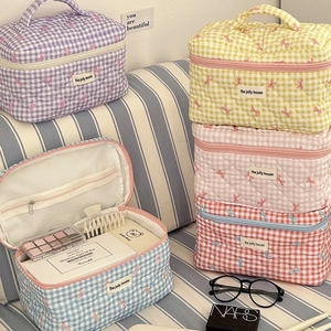 Quilted plaid makeup bag with bow embroidery and top handle in various pastel colors