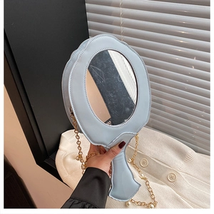 Detail of light blue mirror-shaped bag with baroque embroidery and pearl gold chain