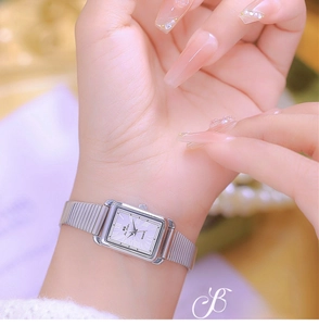 Close-up of elegant silver square watch for women with Roman numerals on a wrist