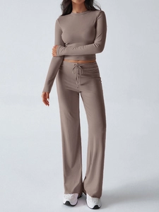 Detailed side view of a brown two-piece set with a long-sleeve crop top and wide-leg pants