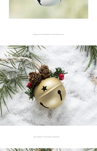 Detail of gold Christmas bell with pine cones, red berries, and star cutout on snow