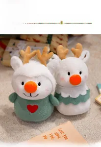 Close-up of plush Christmas reindeer dolls in green and white with soft antlers