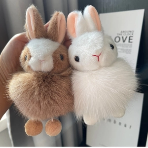 Close-up of plush bunny keychains with fluffy fox fur texture and cute stitched details