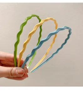 Close-up of wavy candy-colored headbands with matte finish and non-slip inner teeth