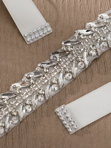 Detail of luxury bridal belt with sparkling marquise crystals and white satin ribbon