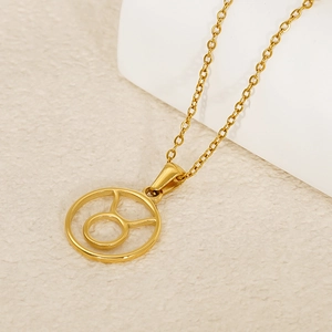Macro view of gold titanium Taurus zodiac hollow circular pendant and delicate link chain
