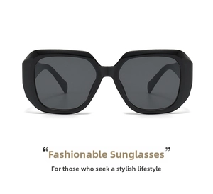 Detail of square oversized black sunglasses with high-gloss finish and dark gray lenses