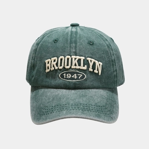 Close-up of vintage washed green baseball cap with 3D Brooklyn 1947 embroidery detail