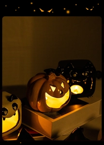Ceramic Halloween tea light holders featuring orange pumpkin, black bat, and white ghost designs