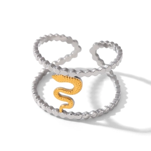 Detail of a dual-layer silver ring featuring a textured gold snake on a beaded wavy band