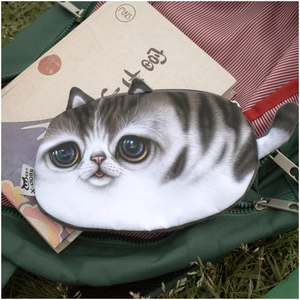 Detailed view of cat-shaped plush coin purse with stripes and 3D ears on a green backpack