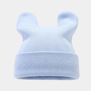 Macro detail of light blue knit hat featuring cute animal ears and soft wool texture
