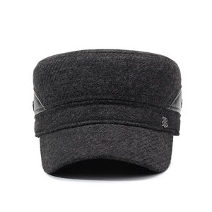 Men's wool flat top winter cap in dark grey with ear flaps and side metal badge