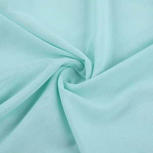 Detailed macro view of light blue breathable mesh fabric with fine honeycomb texture