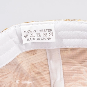 Detailed close-up of the interior lining, washing label, and golden sequin fabric