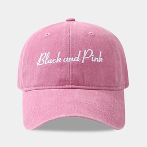 Detailed texture of washed pink cotton canvas on baseball cap with white embroidery