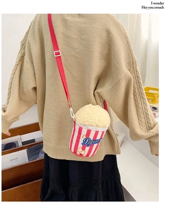 Vue détaillée d'un joli sac en peluche en forme de pop-corn porté par un mannequin en pull.
