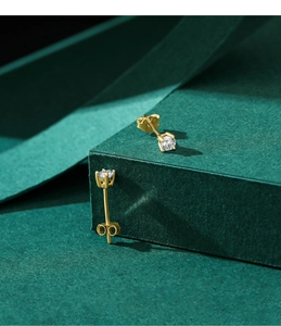 Detailed macro shot of 925 silver four-prong stud earrings with sparkling round cut stones