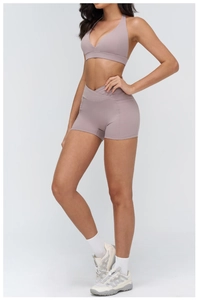 Detail of high-waist yoga shorts with V-shaped crossover waistband in dusty purple