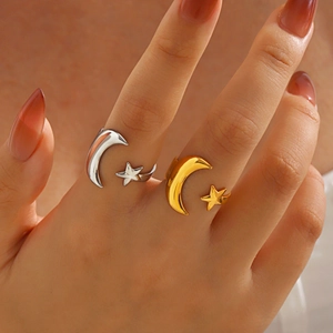 Adjustable stainless steel moon and star ring in gold and silver finish on finger