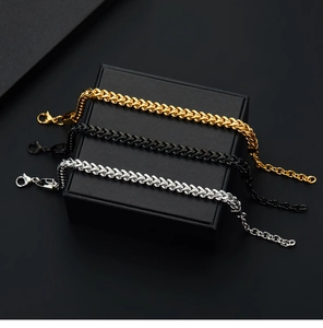 Three-color woven stainless steel fox-tail bracelets in gold, black, and silver