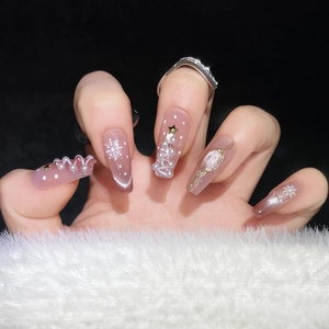 Detail of Christmas cat eye press-on nails with 3D pearl tree and snowflake designs