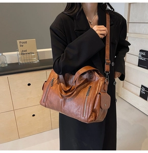 Detailed view of brown PU leather tote bag capacity and pockets in a lifestyle setting