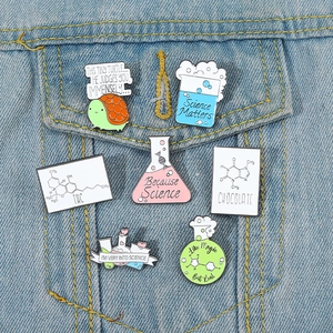 7-piece set of colorful science enamel pins with lab flasks on denim jacket pocket