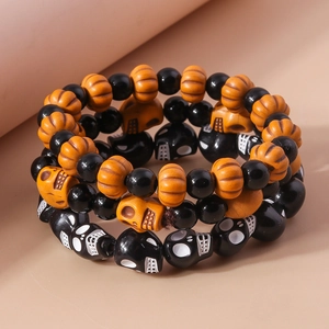 Detail of Halloween beaded bracelet set with orange pumpkins and black skulls beads