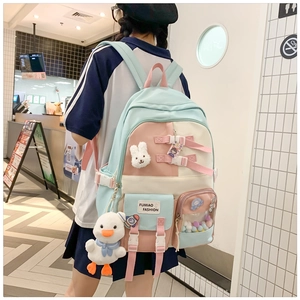 Detail of cute school backpack with pastel colors, bunny pendant and side mesh pocket