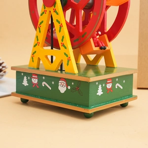 Close-up of a wooden Christmas Ferris wheel music box with Santa and snowman details