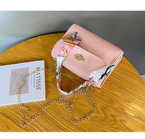 Pink croc-effect mini bag featuring golden twist lock and silk scarf chain strap detail