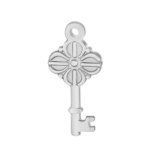 Macro view of a silver clover-patterned stainless steel key pendant for jewelry making