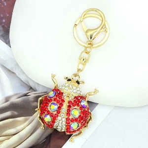 Detailed close-up of a ladybug keychain with sparkling red and multi-color rhinestones