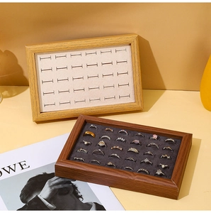 Macro shot of walnut wood jewelry trays with velvet slots for ring storage display