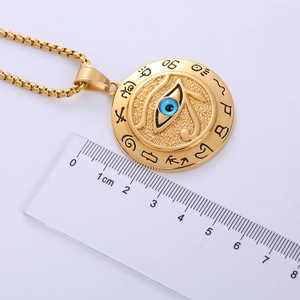 Detail showing Eye of Horus gold pendant with 4cm diameter scale measurement