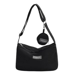Black nylon tote bag with wide shoulder strap and detachable coin purse on white background