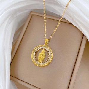 Golden titanium steel Virgin Mary necklace with crystal halo on beige velvet box