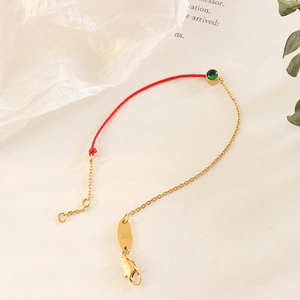 Red cord and gold plated chain bracelet with green gemstone and lobster clasp