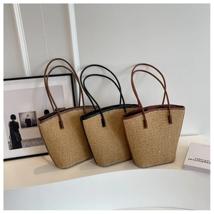 Detailed texture of natural straw tote bags with premium brown and black leather handles