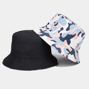 Close-up of black and pink camouflage cotton bucket hats with wide brim and round top