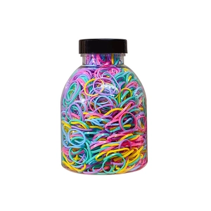 Jar of colorful elastic hair bands for women's hairstyles in a clear storage bottle