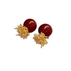 Elegant gold flower earrings with deep red pearls and sparkling crystal accents