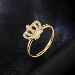 18K gold plated copper crown ring with micro-set zircon on a dark textured background