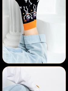 Detailed view of Halloween crew socks featuring skeleton patterns and orange cuffs