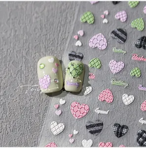 Detailed macro view of 3D embossed heart nail stickers with quilted macaron textures