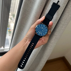 Detailed view of the blue dial and black silicone strap on this quartz wristwatch