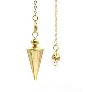 Detailed view of golden copper cone pendulum pendant with textured bead and chain link