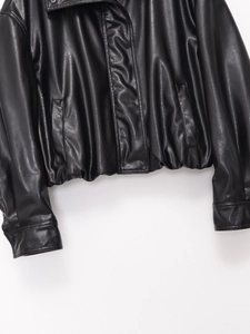 Detail of the high collar black faux leather bomber jacket showing premium stitching and texture