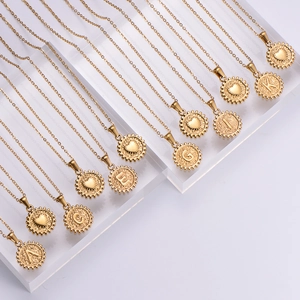 Polished 18k gold plated stainless steel initial letter necklaces on display